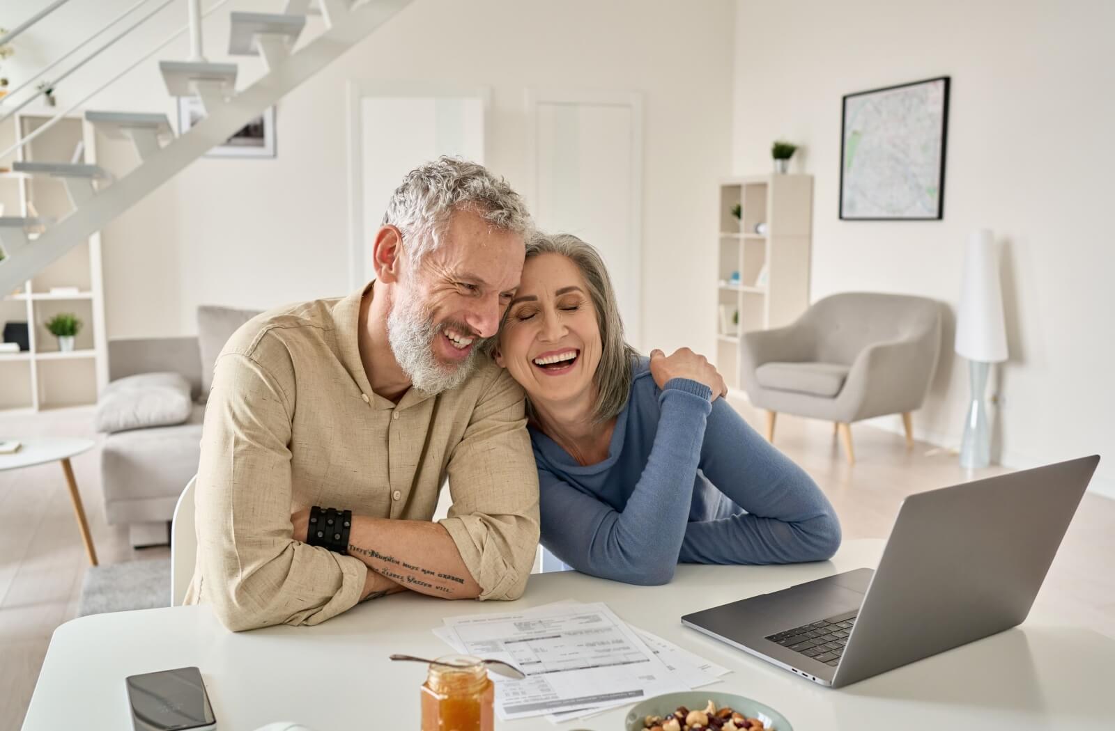: A happy, mature couple safely navigating the internet.