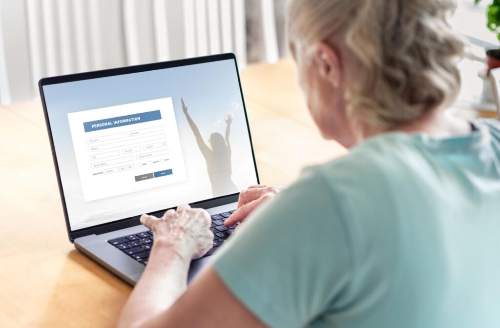 A mature adult sharing their personal information using their laptop.